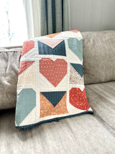 Load image into Gallery viewer, Colorful heart-themed quilt in coral, blue, and white, made from soft fabric for cozy home decor.