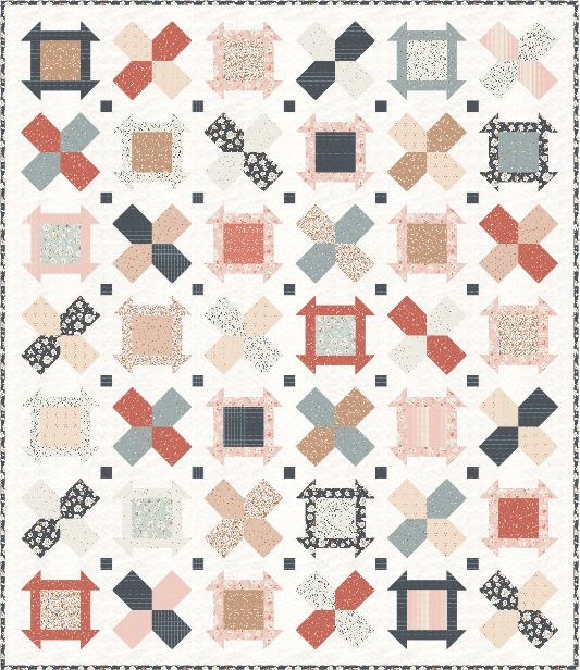 Colorful patchwork quilt in soft pink, blue, and navy tones, featuring intricate floral and geometric patterns.
