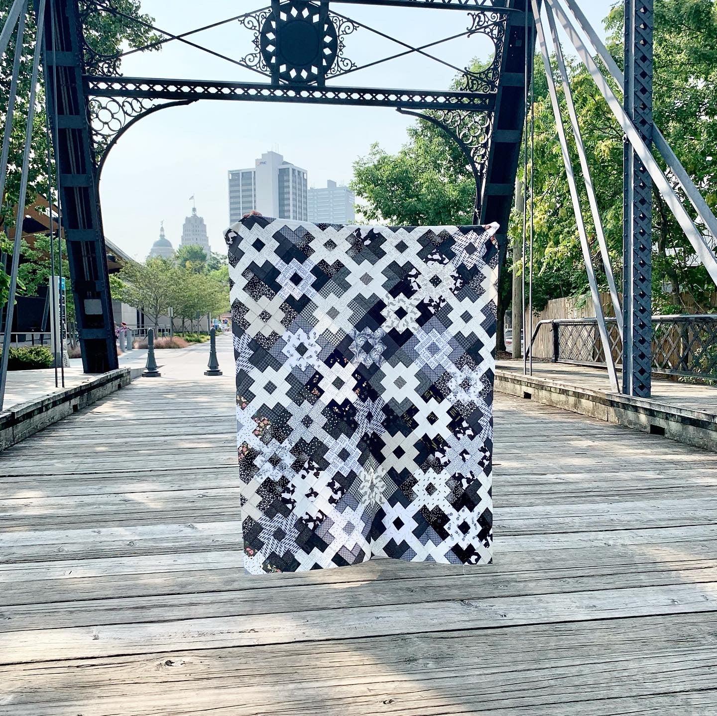 Black and white patterned quilt featuring geometric designs, perfect for home decor or cozy bedding.
