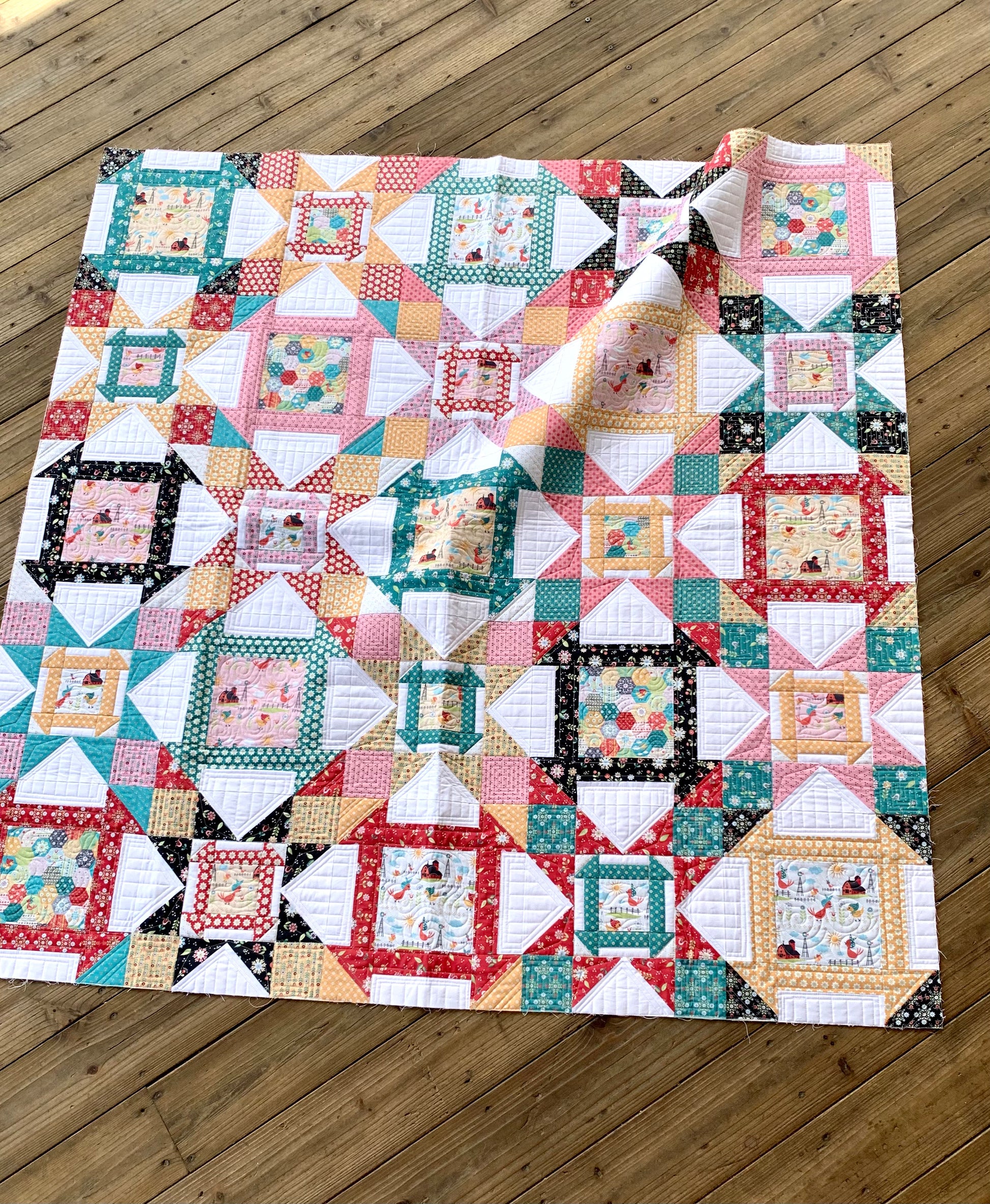 Colorful patchwork quilt with floral and geometric patterns, made from cotton fabric, perfect for home decor.