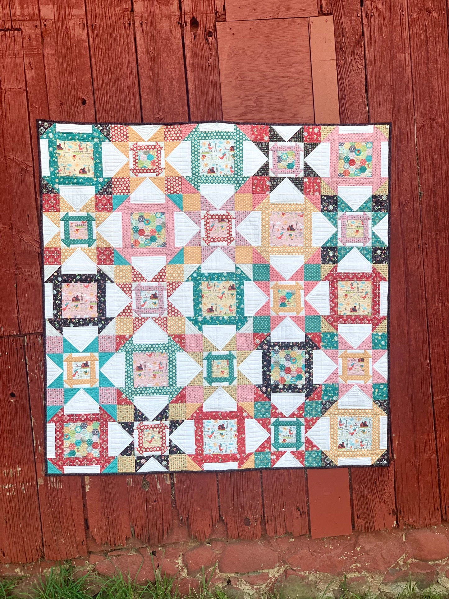 Colorful quilt with geometric patterns, featuring cotton fabric in pastel colors and playful designs.