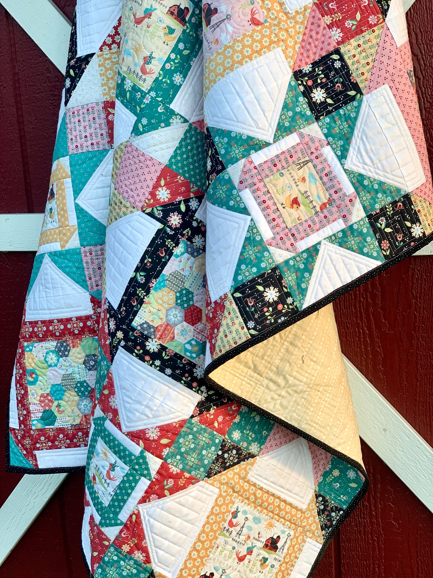 Colorful quilt with floral and geometric patterns, featuring cotton material, perfect for home decor or gifting.
