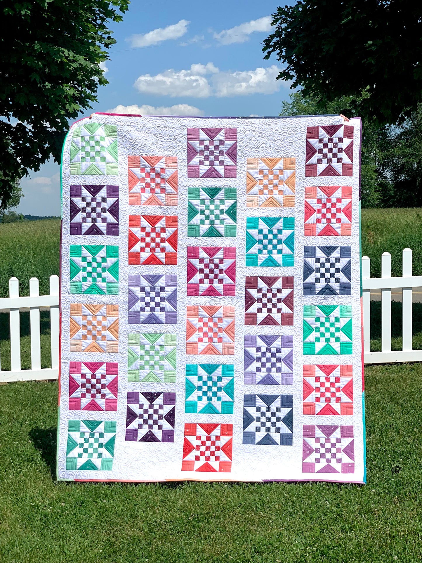 Colorful patchwork quilt featuring star patterns, made of high-quality cotton, perfect for home decor.