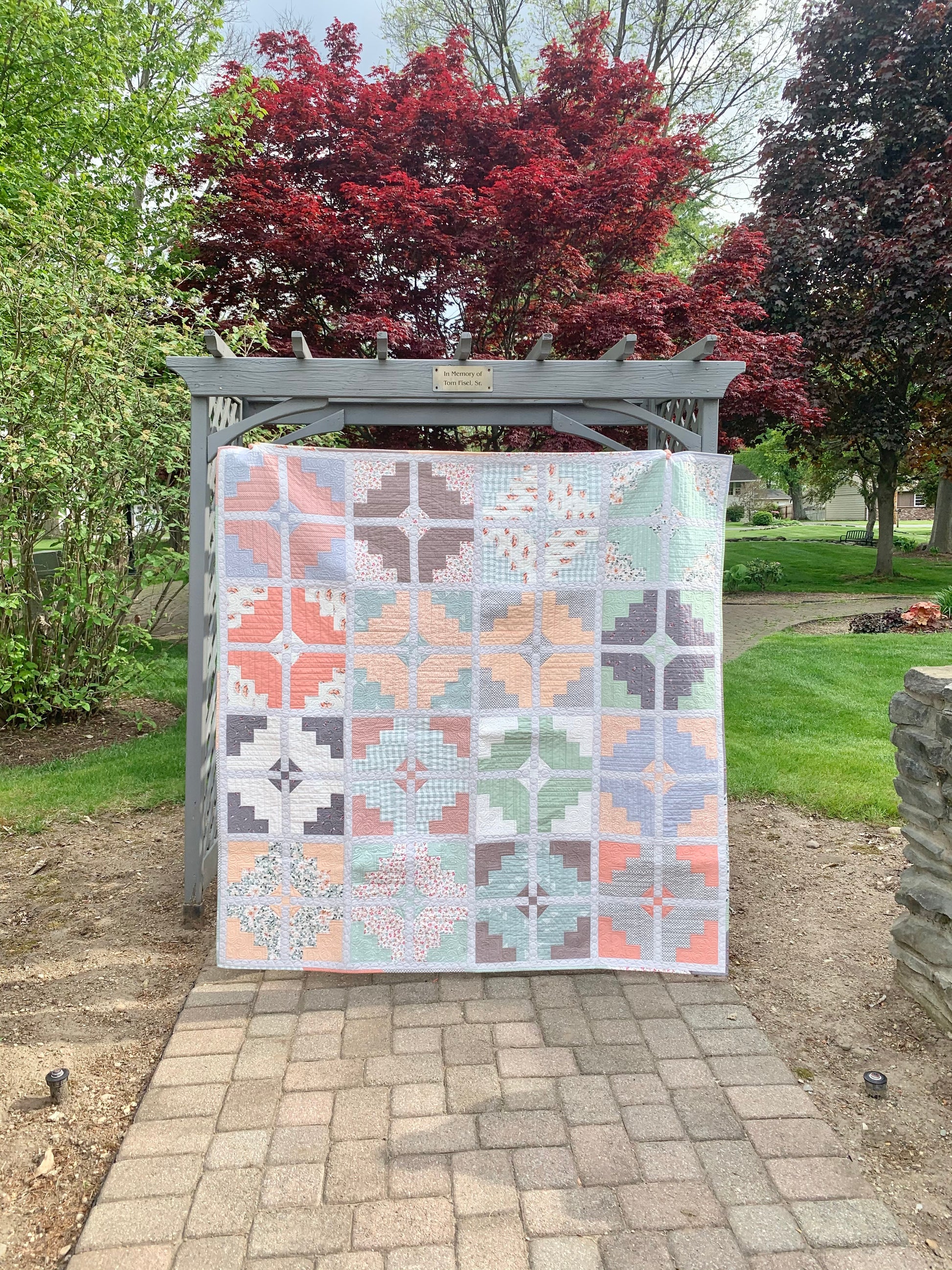 Colorful patchwork quilt featuring geometric designs, soft cotton fabric, perfect for home decor.