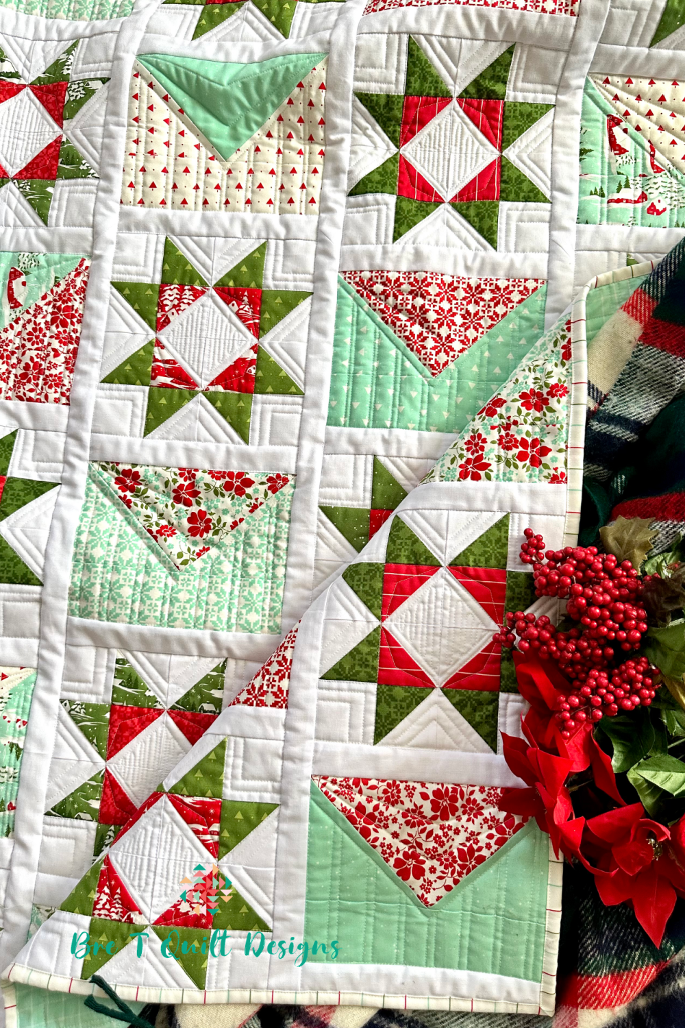 Festive quilt in red, green, and mint with star patterns, perfect for holiday decor or gifts.