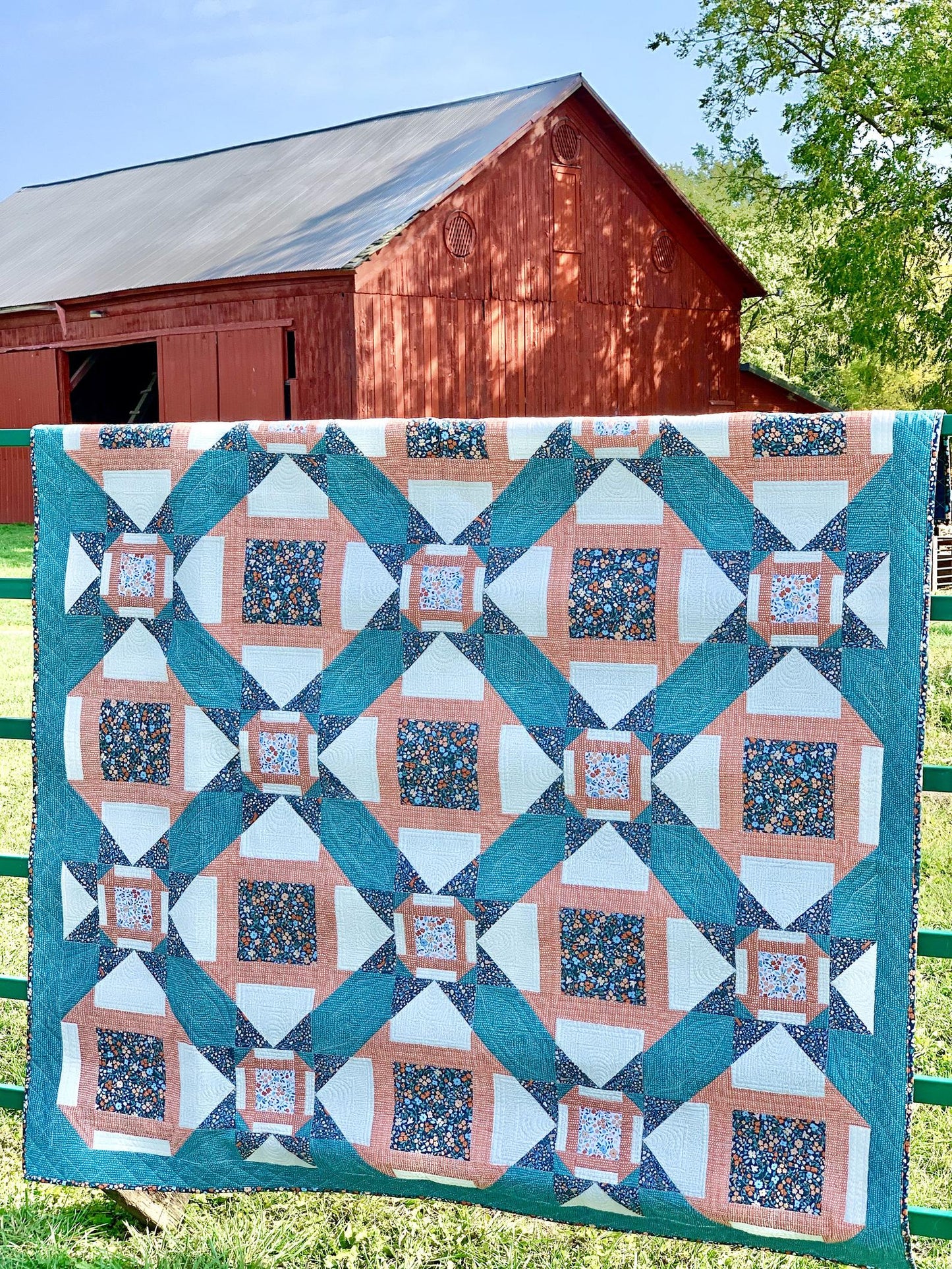 Colorful quilt featuring floral patterns, teal and coral designs, perfect for home decor or gifts.