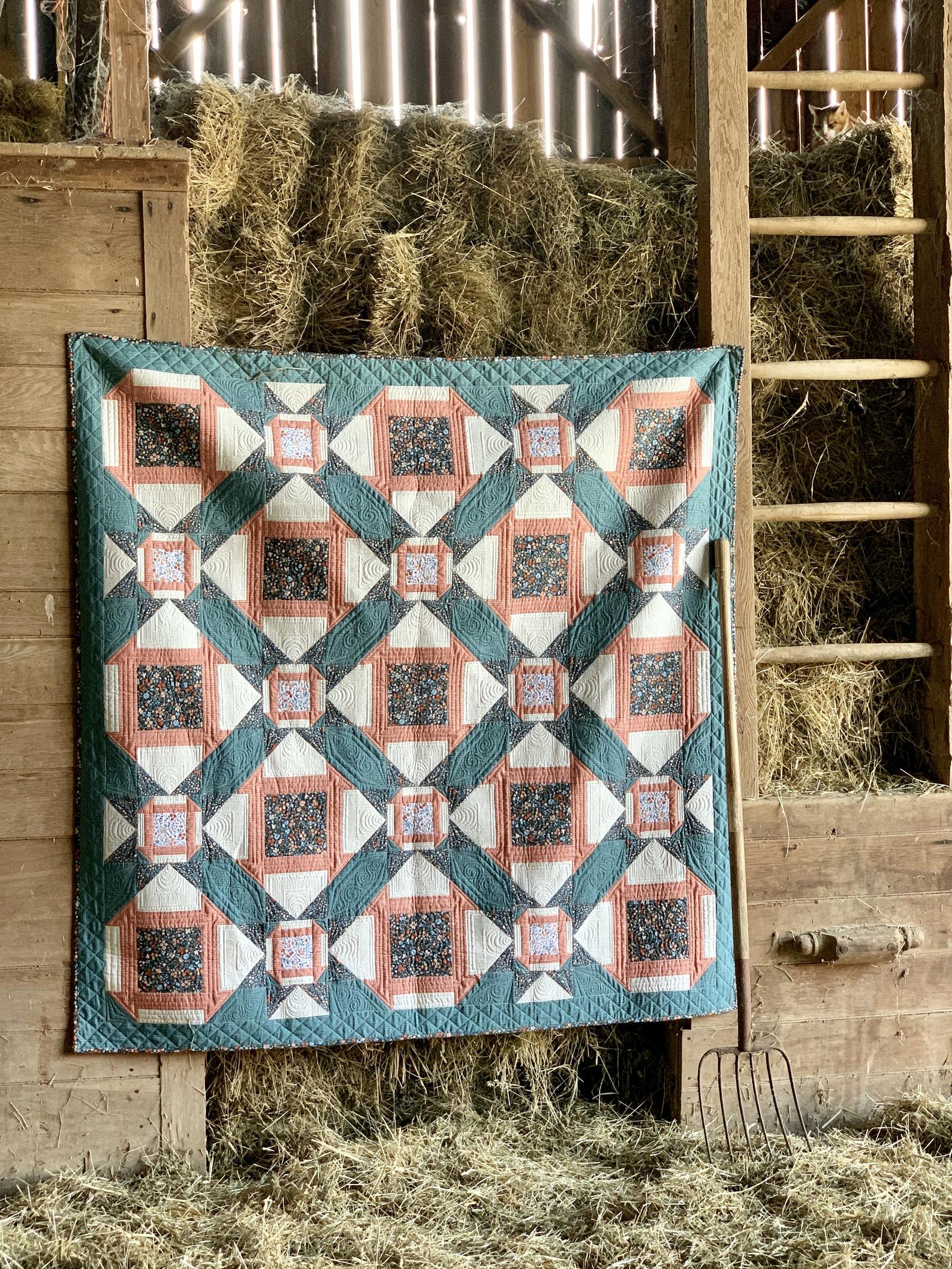 Colorful quilt featuring a geometric design in teal, coral, and cream, perfect for cozy home decor.